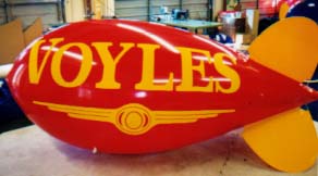 Advertising Blimps - Voyle's logo - we manufacture our helium advertising balloons and helium advertising blimps in the USA.